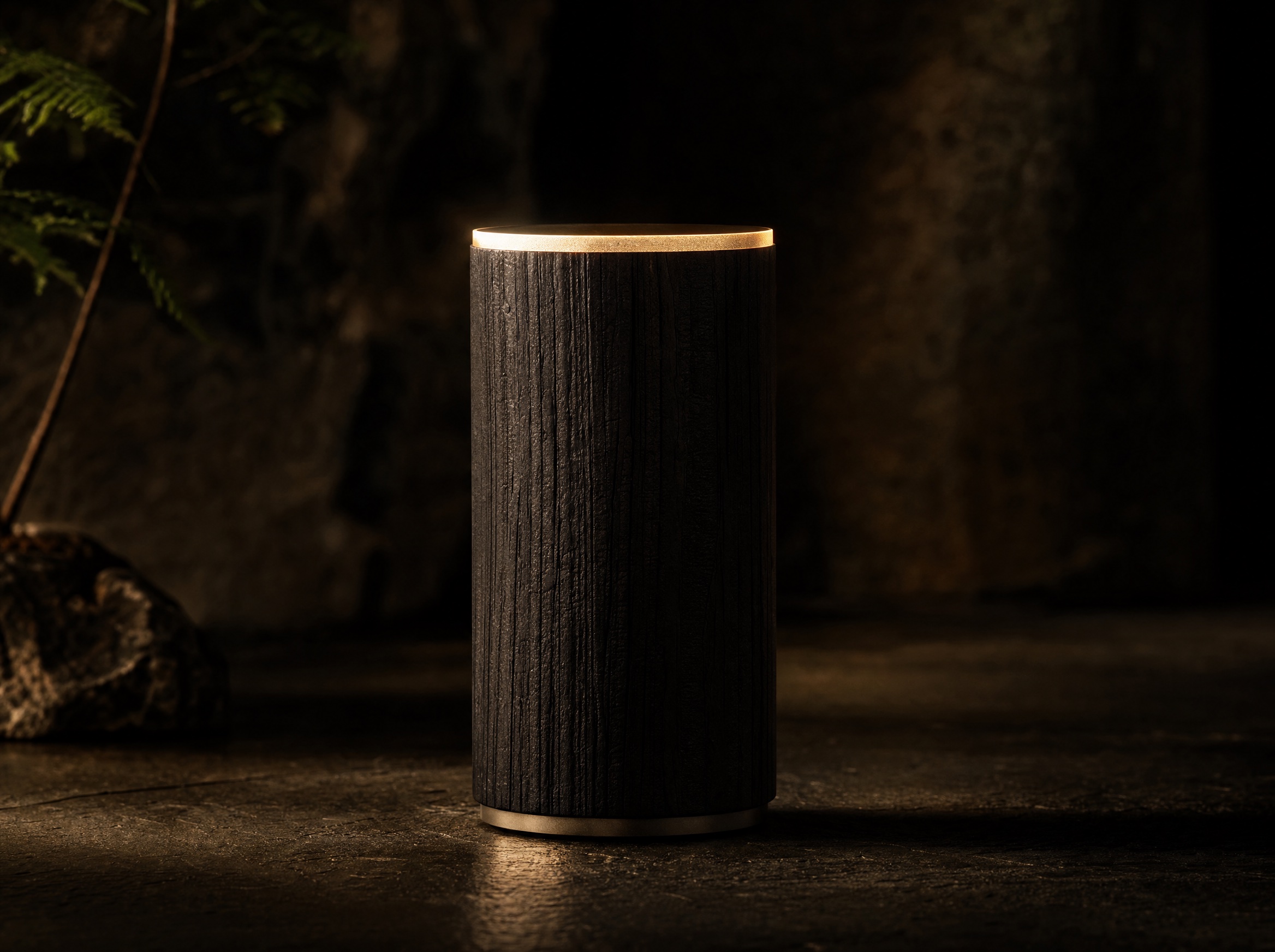 The MA speaker, a charred cedar column crowned with a ring of warm light